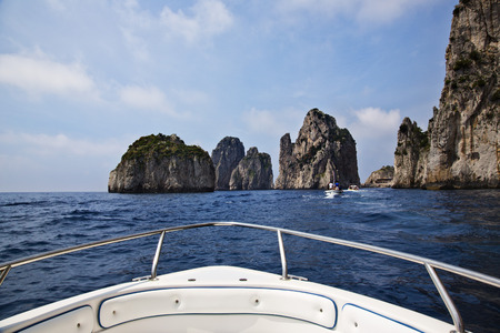 Boat in the sea with cliffs , Capri, Naples Province, Campania, Italyの写真素材