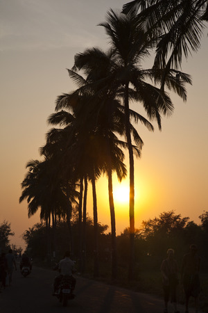 People on the road at dusk, Goa, Indiaの写真素材