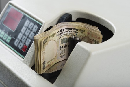 500 Hundred Indian banknotes being counted in a machineの写真素材