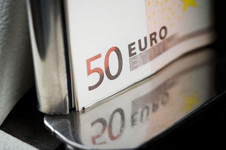 Fifty Euro notes being counted in a machineの写真素材