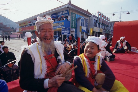 Senior man and boy performer in traditional costume sitting together and smilingのeditorial素材