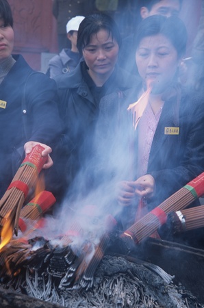 People burning joss sticks in a templeのeditorial素材