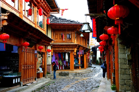 A street with traditional buildings and shops in Yunnan Province, Chinaのeditorial素材