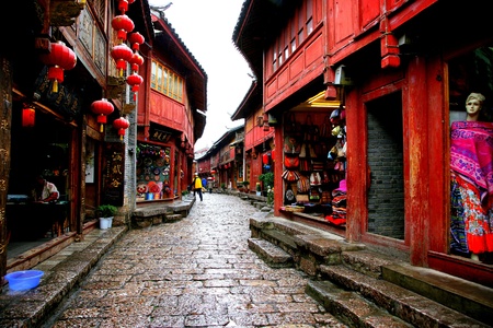 A street with traditional buildings and shops in Yunnan Province, Chinaのeditorial素材
