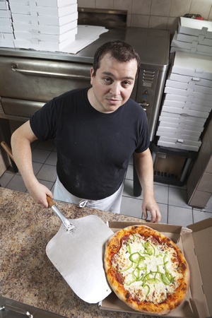 Chef with fresh take out pizza の写真素材