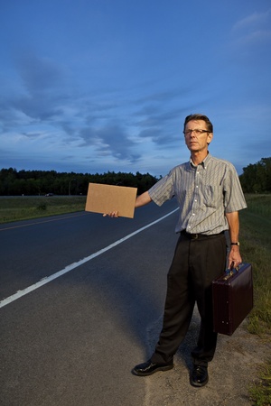 Businessman hitchhiking to work の写真素材