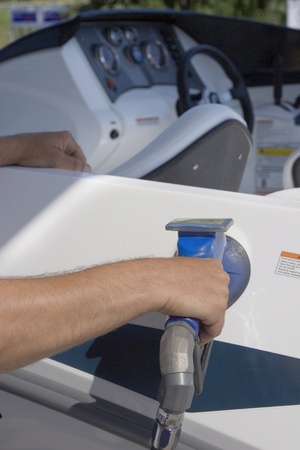 Man filling his boat with fuel at a gas station の写真素材