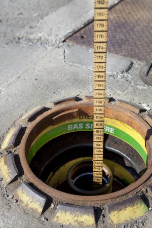 Measuring gasoline inventory with a dip stick の写真素材