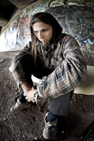 Homeless alcoholic drinking beer の写真素材