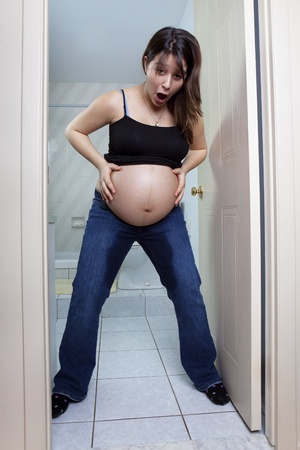 Young pregnant woman just broke her water の写真素材