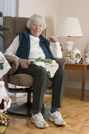 Senior woman knitting vertical の写真素材