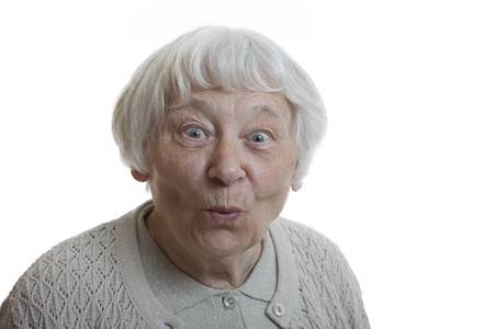 Senior woman studio portrait Happy surprised puckering の写真素材