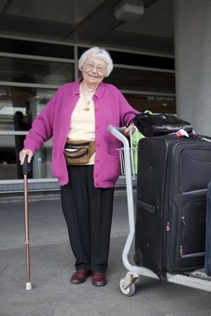 Senior woman travelling with luggage の写真素材