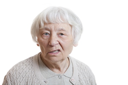 Senior woman studio portrait disappointed (Mouth lips side) の写真素材