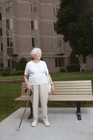 Senior woman waiting at a bus stop の写真素材