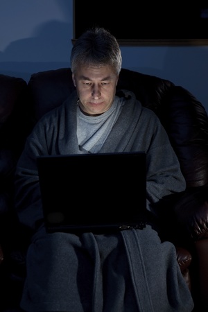 Man in housecoat working late series serious の写真素材
