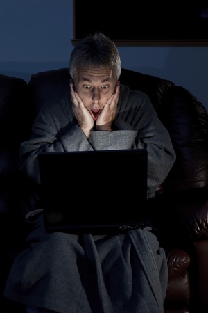 Man in housecoat working late series surprised の写真素材
