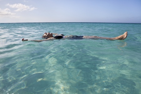 Woman floating and relaxing in the sea の写真素材