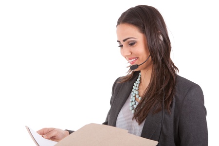 Businesswoman reading a file while on the phone の写真素材