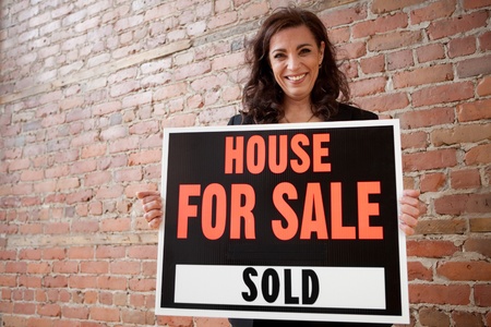 Happy homeowner sold her house の写真素材
