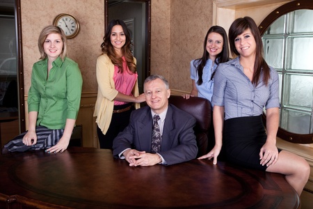 Senior executive with team of young women の写真素材