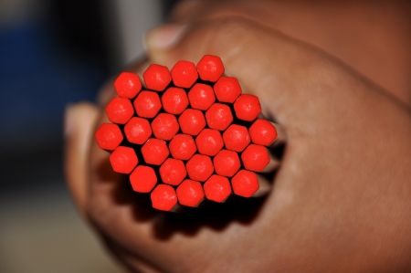 View of hands holding pencils