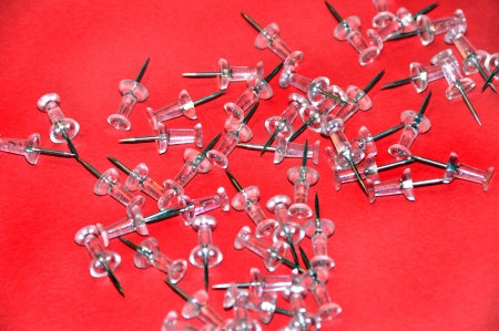 Pushpins on red background