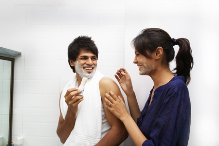 Young couple playing with shaving creamの写真素材