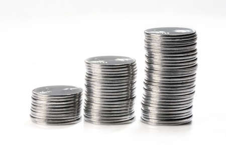 Coins arranged in stacks against white background