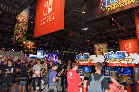 Cologne, Germany - August 24, 2017: Trade fair visitors playing games and waiting  at the booth of the company Nintendo at Gamescom 2017. Gamescom is a trade fair for video games held annually in Cologne.のeditorial素材