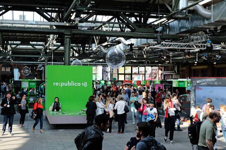 Berlin, Germany - May 3, 2018: View on the entrance hall of re:publica 2018 with visitors and many small booths. re:publica is a conference about Web 2.0, weblogs, social media and the digital society.のeditorial素材