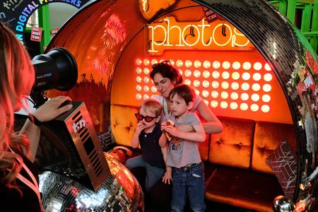 Berlin, Germany - May 3, 2018: Employee of the t3n computer magazin takes a promo photo at their booth of a visitor family. re:publica is a conference about Web 2.0, weblogs, social media and the digital society.のeditorial素材