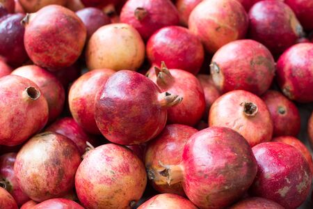 Bunch of red pomegranates at the marketの写真素材
