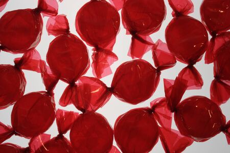 Red hard candies on white background.