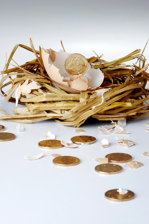 Coins coming out from a broken egg