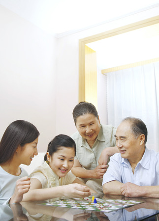 Family playing board game togetherの写真素材