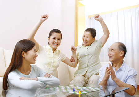 Family playing board game togetherの写真素材