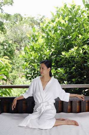 Woman in bathrobe relaxing at a spaの写真素材