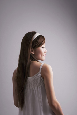 Woman with head band looking to the sideの写真素材