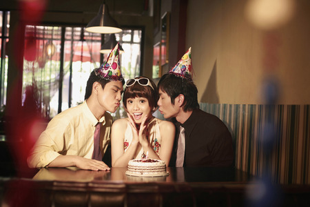 Woman celebrating birthday with friendsの写真素材