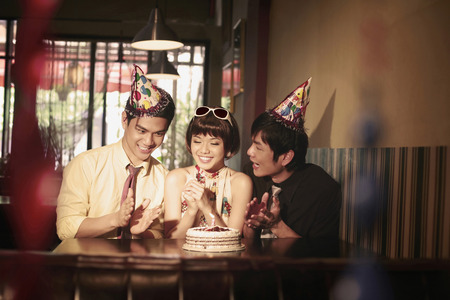 Woman celebrating birthday with friendsの写真素材
