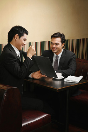 Businessman explaining contents of document to his clientの写真素材