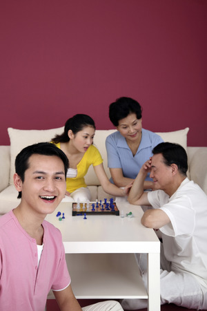 Man smiling, senior woman and woman consoling senior man in the backgroundの写真素材