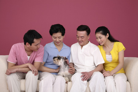 Family playing with their favourite pet dogの写真素材