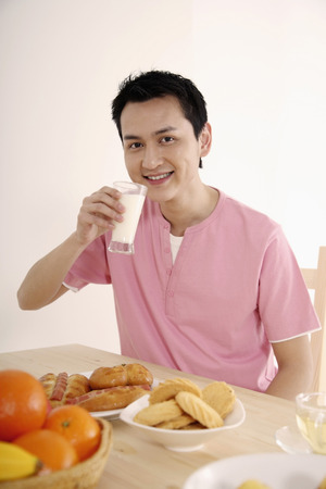 Man enjoying a glass of milkの写真素材