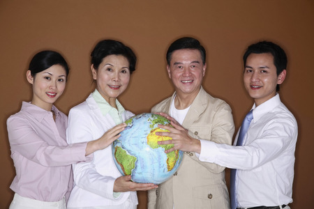 Men and women touching the globeの写真素材