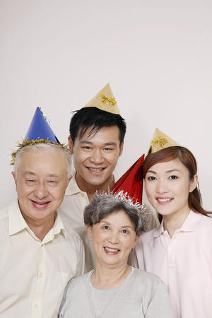 Happy family wearing party hatの写真素材