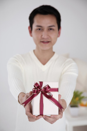 Man holding a box of giftの写真素材