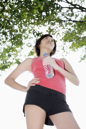 Woman holding water bottleの写真素材