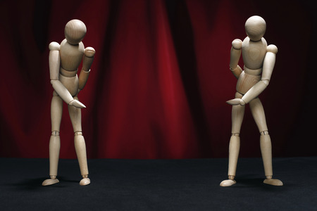 Two wooden dummies taking a bow on stageの写真素材